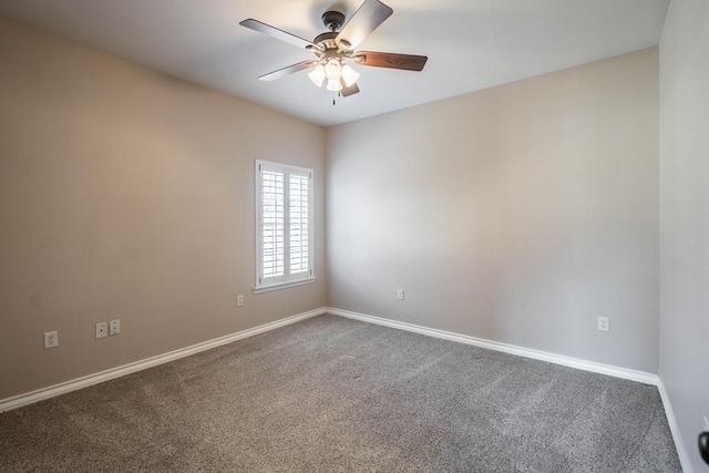 carpeted spare room featuring ceiling fan