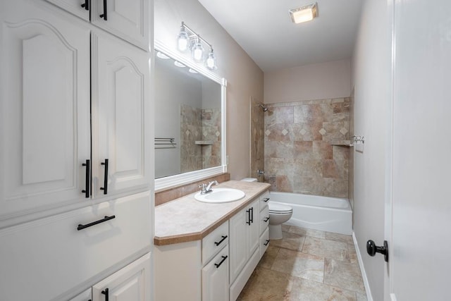 full bathroom with toilet, tiled shower / bath combo, and vanity