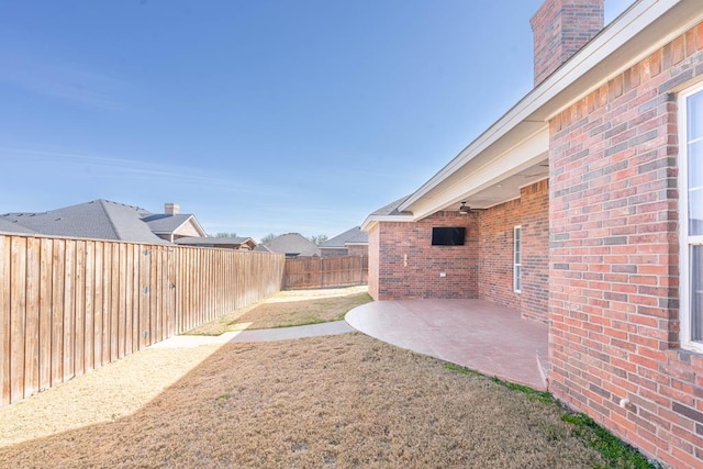 view of yard featuring ceiling fan and a patio area