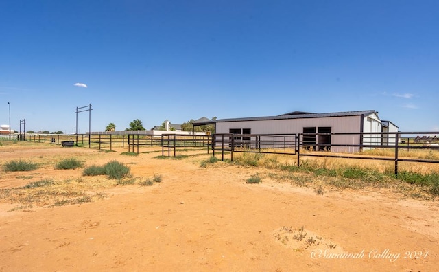 view of stable featuring a rural view