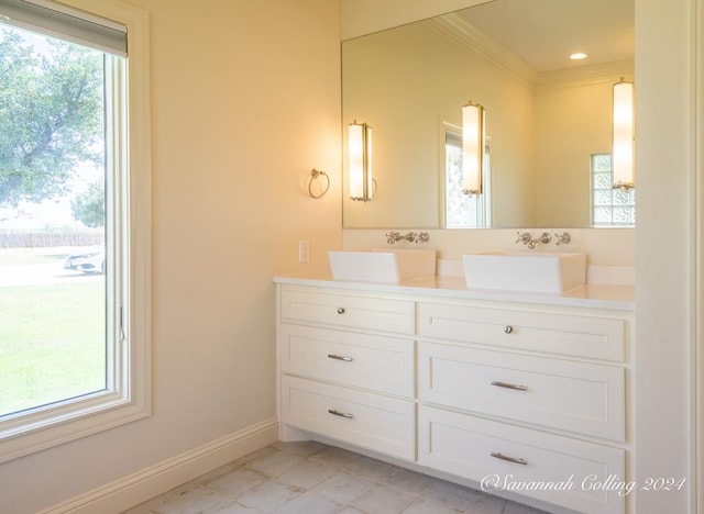 bathroom featuring vanity, plenty of natural light, and ornamental molding