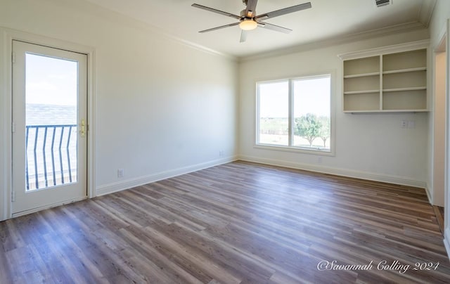 empty room with ceiling fan, dark hardwood / wood-style floors, and ornamental molding