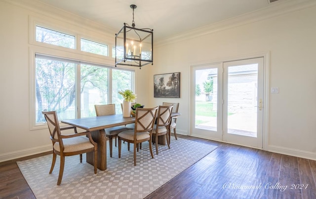 dining space featuring a chandelier, hardwood / wood-style floors, and ornamental molding