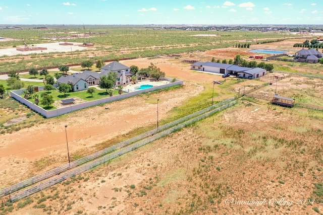 birds eye view of property with a rural view