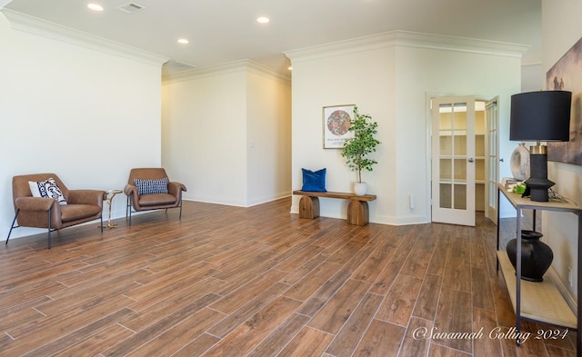 sitting room featuring hardwood / wood-style floors and crown molding