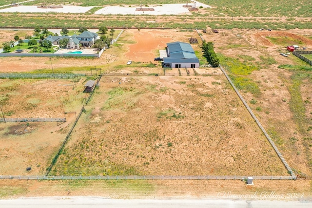 birds eye view of property with a rural view