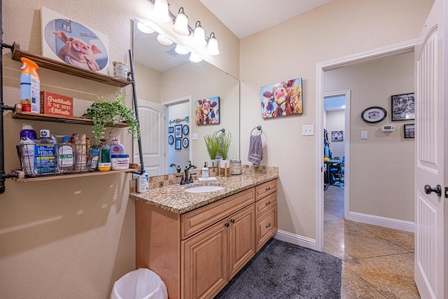 bathroom featuring vanity and baseboards
