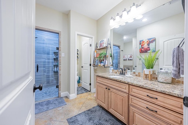 full bath featuring a stall shower, toilet, tile patterned flooring, and vanity
