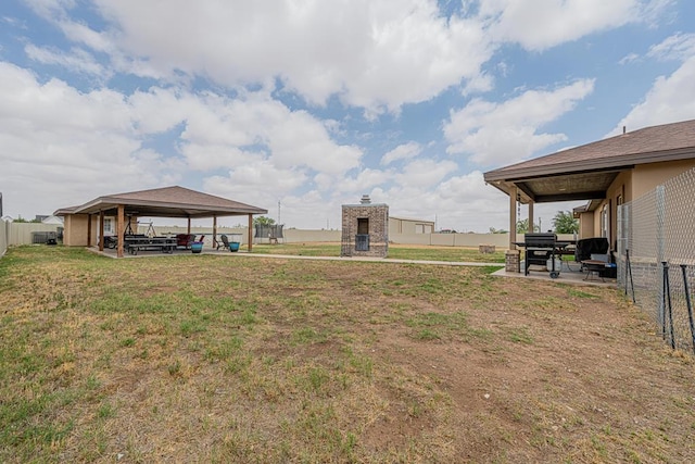 view of yard with fence and a carport