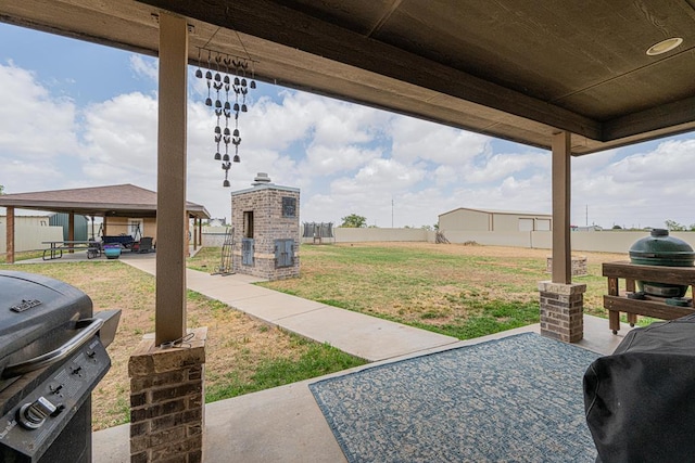 view of patio with a gazebo, grilling area, and fence