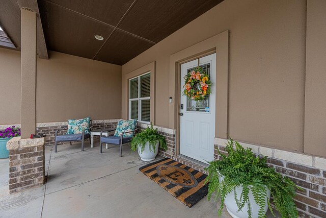 view of exterior entry featuring a porch