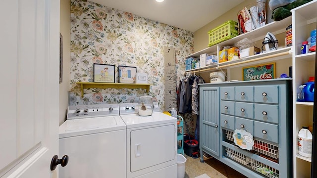 laundry room featuring wallpapered walls, laundry area, and washer and clothes dryer