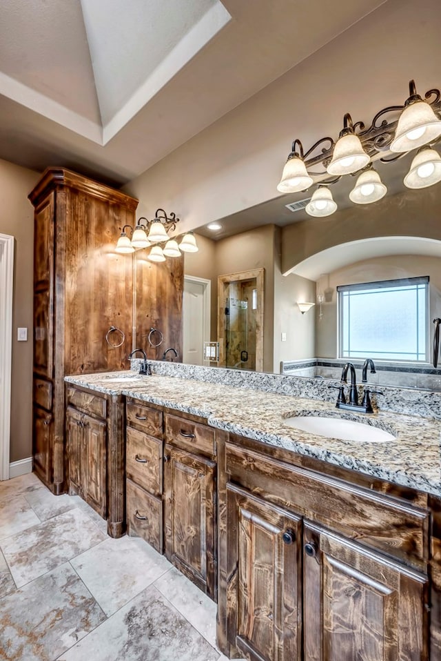 bathroom with vanity and vaulted ceiling