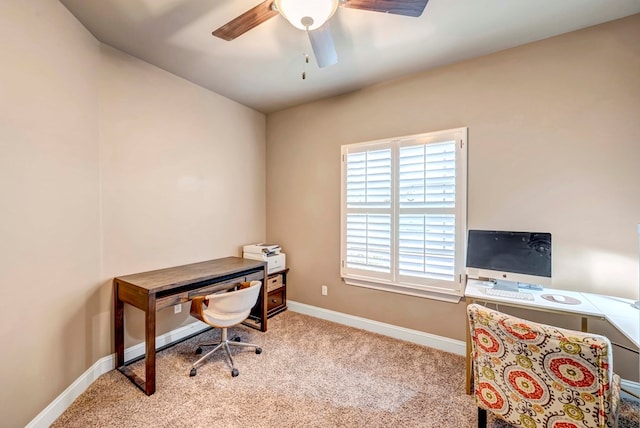 home office featuring light carpet and ceiling fan