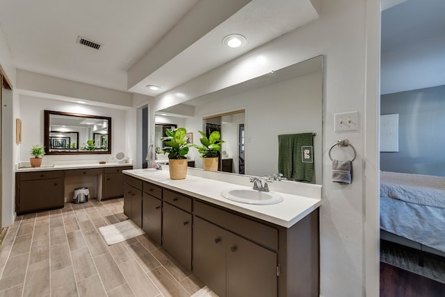 full bath with visible vents, ensuite bath, wood tiled floor, vanity, and recessed lighting