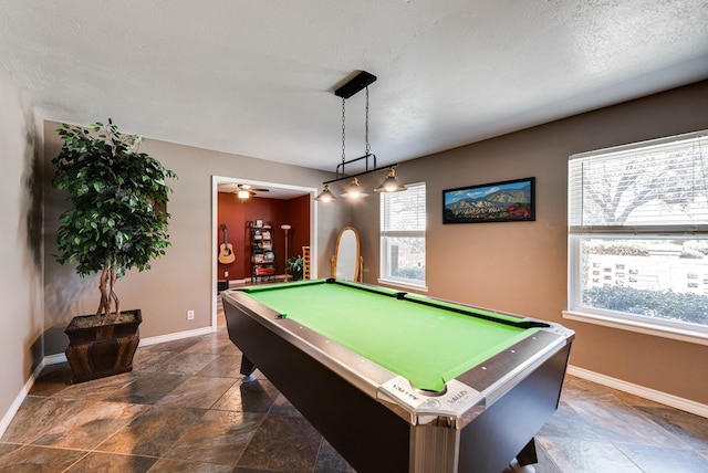 rec room with pool table, ceiling fan, a textured ceiling, and baseboards