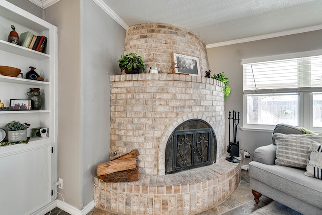 living area featuring built in features, crown molding, a brick fireplace, a textured ceiling, and baseboards