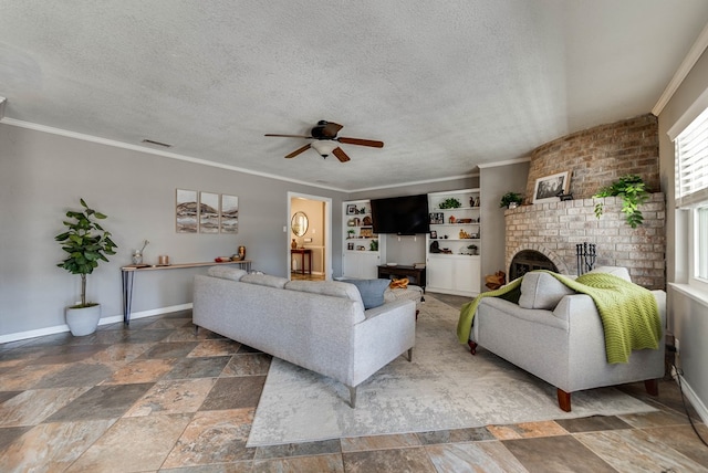 living area featuring a textured ceiling, ornamental molding, a fireplace, and visible vents