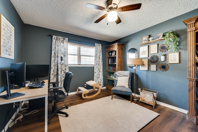 office featuring ceiling fan, a textured ceiling, baseboards, and wood finished floors