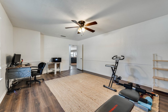 home office with dark wood-style floors, baseboards, visible vents, and ceiling fan