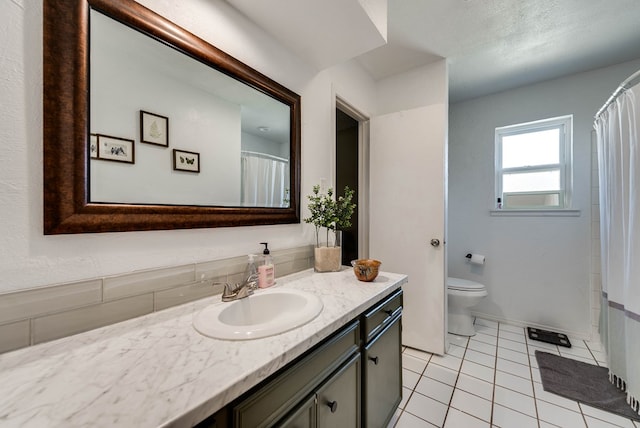 full bathroom featuring curtained shower, vanity, toilet, and tile patterned floors