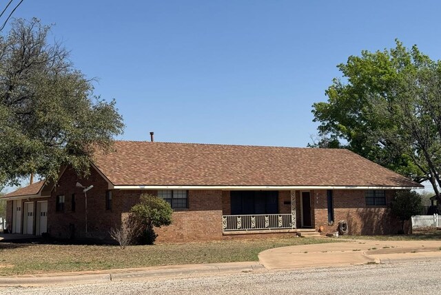 ranch-style house with brick siding, driveway, a porch, and a garage