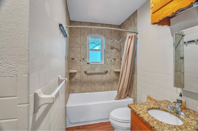 312 N Main St, Coahoma, TX 79511 - bathroom featuring toilet, tile walls, wood finished floors, shower / tub combo with curtain, and vanity