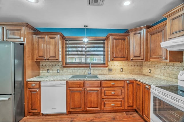 312 N Main St, Coahoma, TX 79511 - kitchen with a sink, white appliances, backsplash, under cabinet range hood, and visible vents
