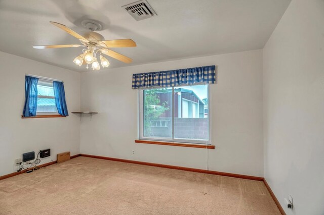312 N Main St, Coahoma, TX 79511 - spare room with visible vents, a ceiling fan, baseboards, and light carpet