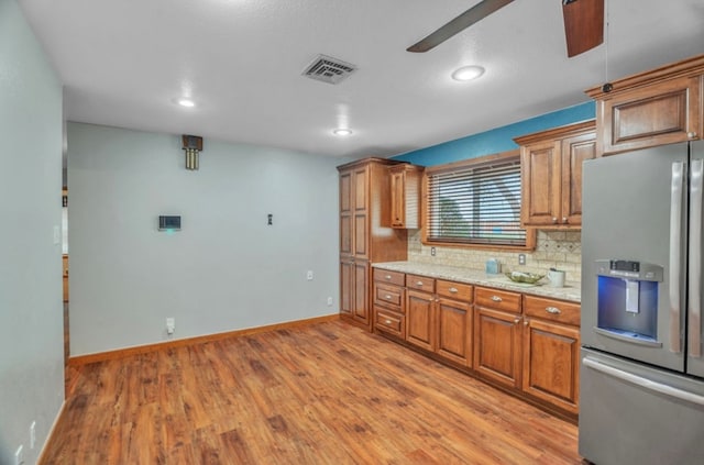312 N Main St, Coahoma, TX 79511 - kitchen with ceiling fan, light wood-style flooring, visible vents, and stainless steel fridge