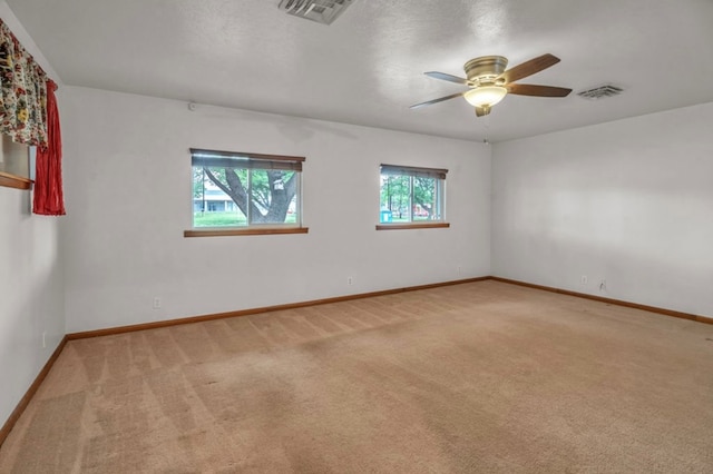 312 N Main St, Coahoma, TX 79511 - unfurnished room featuring light colored carpet, ceiling fan, baseboards, and visible vents