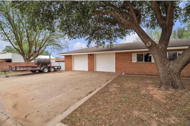 312 N Main St, Coahoma, TX 79511 - exterior space with concrete driveway, an attached garage, and brick siding