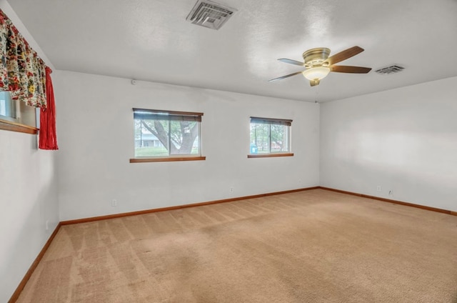 312 N Main St, Coahoma, TX 79511 - spare room featuring baseboards, visible vents, carpet, and ceiling fan