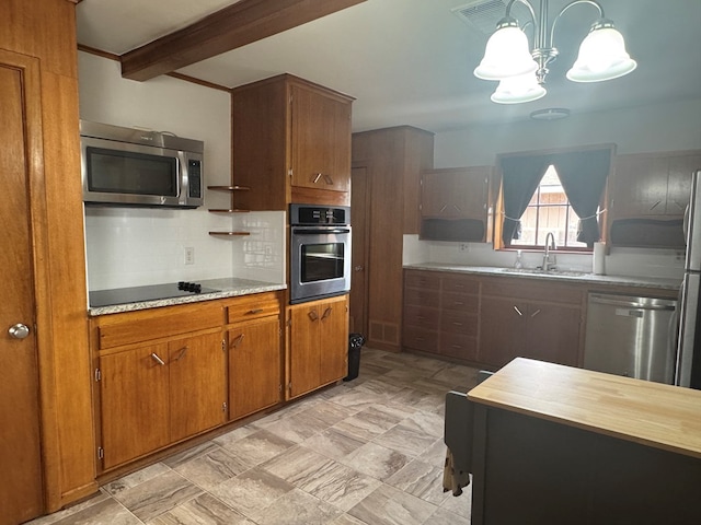 2615 W Golf Course Rd, Midland, TX 79705 - kitchen featuring stainless steel appliances, brown cabinets, decorative backsplash, a chandelier, and beam ceiling