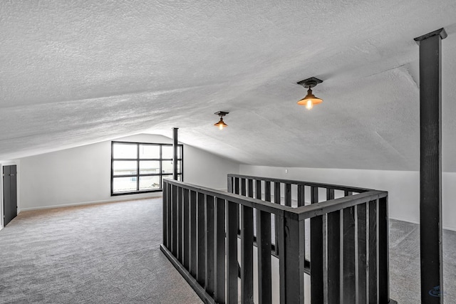 hall with carpet flooring and lofted ceiling