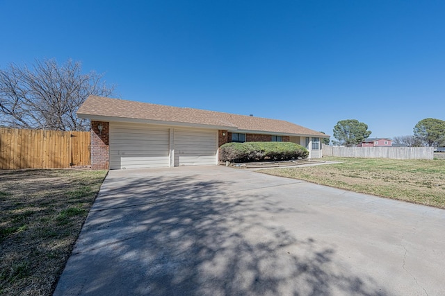 view of front of property with driveway, fence, and brick siding