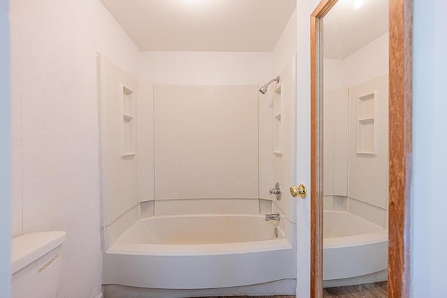 bathroom with tub / shower combination and toilet