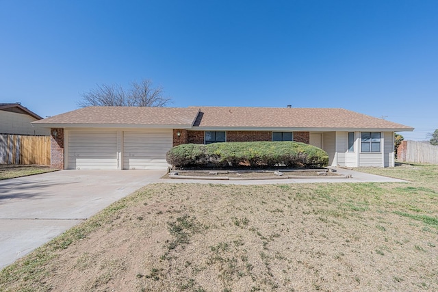 single story home with a garage, brick siding, fence, concrete driveway, and a front lawn