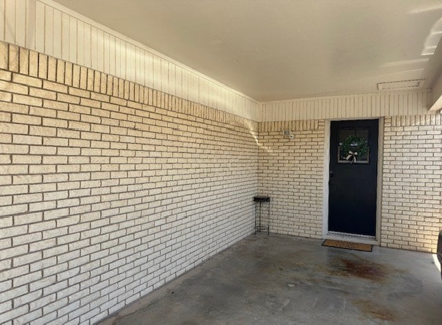 entrance to property with brick siding