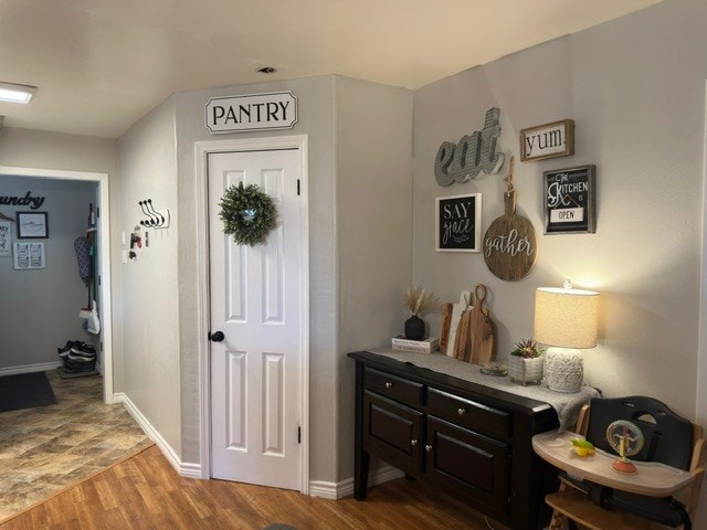 interior space with wood finished floors and baseboards