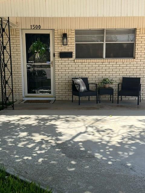 doorway to property with a patio area