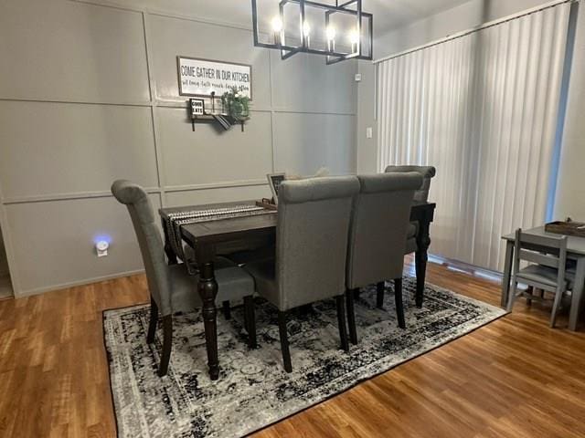 dining room with a decorative wall and wood finished floors