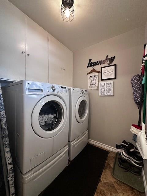 washroom featuring laundry area, independent washer and dryer, and baseboards