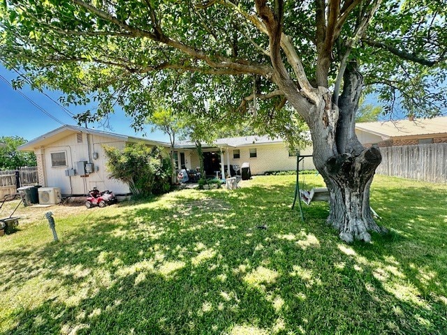 view of yard with ac unit and fence