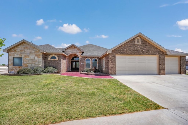 view of front of home featuring a front yard, a shingled roof, an attached garage, concrete driveway, and brick siding