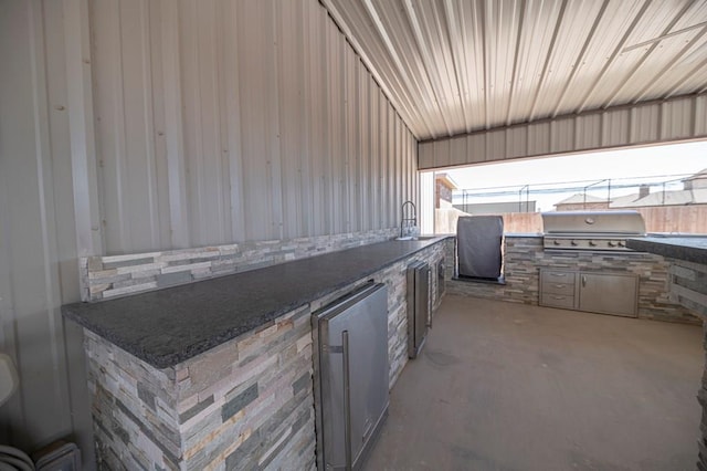 view of patio featuring grilling area, a sink, and an outdoor kitchen