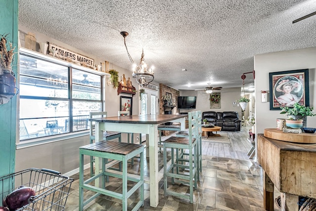 1412 Sparks St, Midland, TX 79701 - dining room featuring ceiling fan, a chandelier, and a textured ceiling