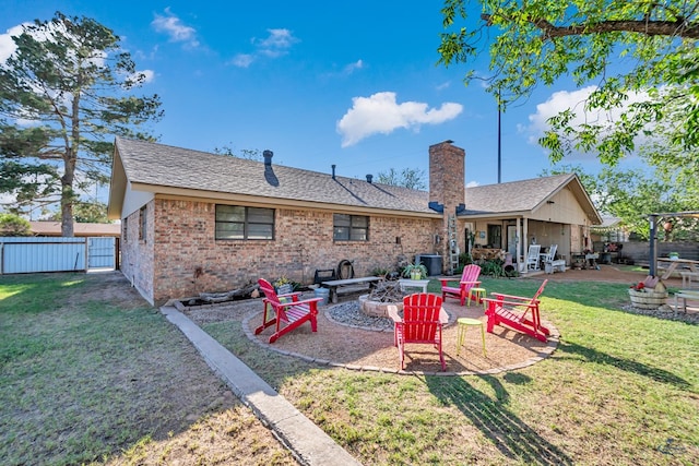 1412 Sparks St, Midland, TX 79701 - back of house featuring a fire pit, a chimney, a patio area, brick siding, and a shingled roof