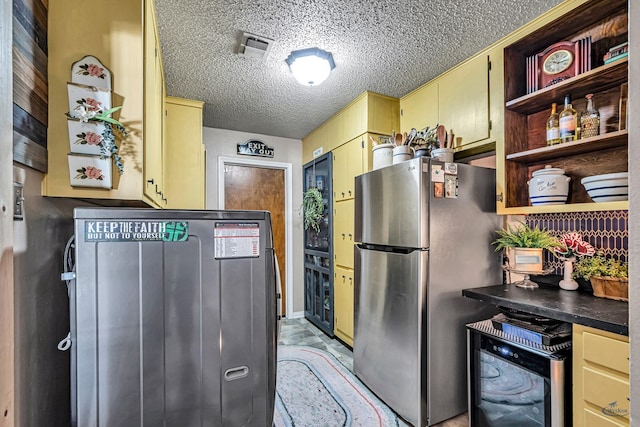 1412 Sparks St, Midland, TX 79701 - kitchen featuring freestanding refrigerator, wine cooler, open shelves, a textured ceiling, and dark countertops