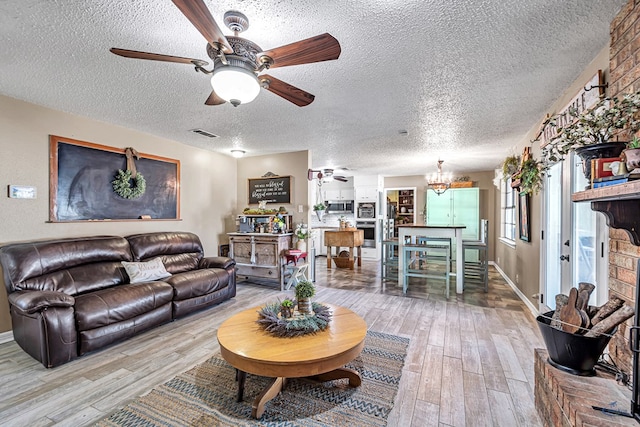1412 Sparks St, Midland, TX 79701 - living area featuring ceiling fan, a textured ceiling, hardwood / wood-style flooring, a chandelier, and baseboards